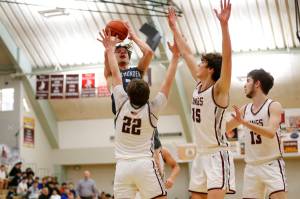 Thunder Mountains Thomas Baxter (30) prepares to shoot the ball as Kayhis Archie Dundas (22), Jared Rhoades (15), and Andrew Kleinschmidt-Guthrie (13) try to block him during Thunder Mountains 54-56 loss to Kayhi on Friday at Ketchikan High School. On Saturday, the Falcons won the rematch 60-58. (Christopher Mullen / Ketchikan Daily News)