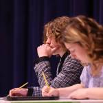 Killian Connolly and Kate Thomas of Ketchikan, who ultimately prevailed, take notes during the final debate at the Region V Drama, Debate and Forensics Tournament. (Ben Hohenstatt / Juneau Empire)
