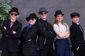 Dane Hubert, Fredrik Hale Thorsteinson IV, Casey Knapp, Alexis Juergens and Finley Hightower, the Fedora Squad, pose for a photo during  the Region V Drama, Debate and Forensics Tournament. (Ben Hohenstatt / Juneau Empire)