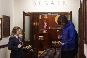 Senate pages Jenna Carpenter and Zaxon Tomaszewski play Off To The Races outside the Senate Chambers exactly 15 minutes before the start of the floor session. Pages then perform the tones alerting senators the session is about to start on all floors of the Capitol where the legislators have offices. The House relies on an electronic bell notification that plays the famous clock chime Westminster Quarters. (Mark Sabbatini / Juneau Empire)