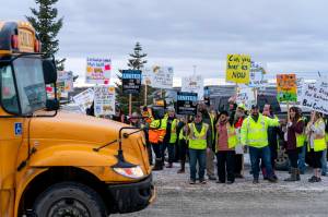 Bus drivers picket outside the bus barn in Wasilla, Alaska on Jan. 26, 2023. Bus drivers in Alaska’s second-largest school district have gone on strike after delivering students to classes on Tuesday,  Jan. 31, citing unfair labor practices. (Loren Holmes / Anchorage Daily News)