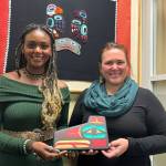 Alannah Johnson and Rebecca Kameika, winners of the 2022 Path to Prosperity Competition, pose for a photo at the formal winners announcement at the 2022 Mid-Session Summit at Southeast Conference Tuesday. In addition to each being awarded $25,000 to help expand their businesses, they each received a Tlingit wall carving, hand-crafted by Brian Chilton. (Jonson Kuhn / Juneau Empire)