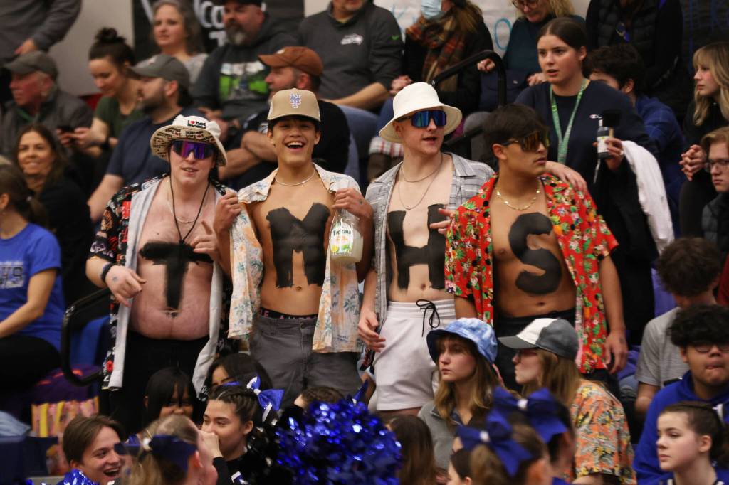 Ben Hohenstatt / Juneau Empire 
Thunder Mountain High School fans don tropical garb during a cross-town basketball game on Thursday at Thunder Mountain High School.