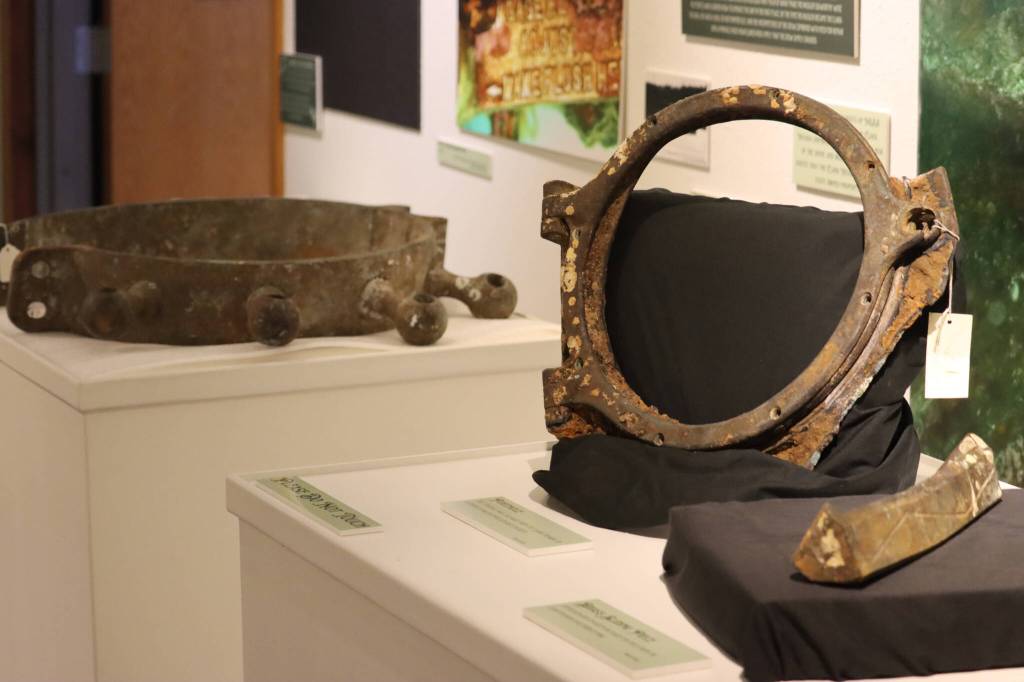 A portion of the Clara Nevadas helm, porthole and brass sliding piece sit on display as part of the Haines Sheldon Museums latest exhibit, A Mystery Lies Beneath the Waves: The Legend of the Clara Nevada, which opened to the public on Feb. 3 to commemorate the anniversary of the ships sinking in 1898. (Jonson Kuhn / Juneau Empire)