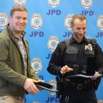 JPD Officers Patrick Vaughan and Ron Shriver receive awards for their involvement within the same incident during the departments award ceremony on Monday. Vaughan received the Medal of Bravery and Shriver received the Outstanding Police Service Medal. (Jonson Kuhn / Juneau Empire)