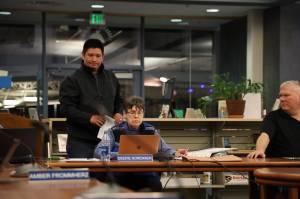 Clarise Larson / Juneau Empire
Nick Nelson passes out paper copies of a notice of appeal to school board members Tuesday night regarding the districts decision on a racism complaint at Juneau-Douglas High School: Yadaa.at Kalé he filed in early December.