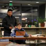 Nick Nelson passes out paper copies of a notice of appeal to school board members Tuesday night regarding the districts decision on a racism complaint at Juneau-Douglas High School: Yadaa.at Kalé he filed in early December. (Clarise Larson / Juneau Empire)