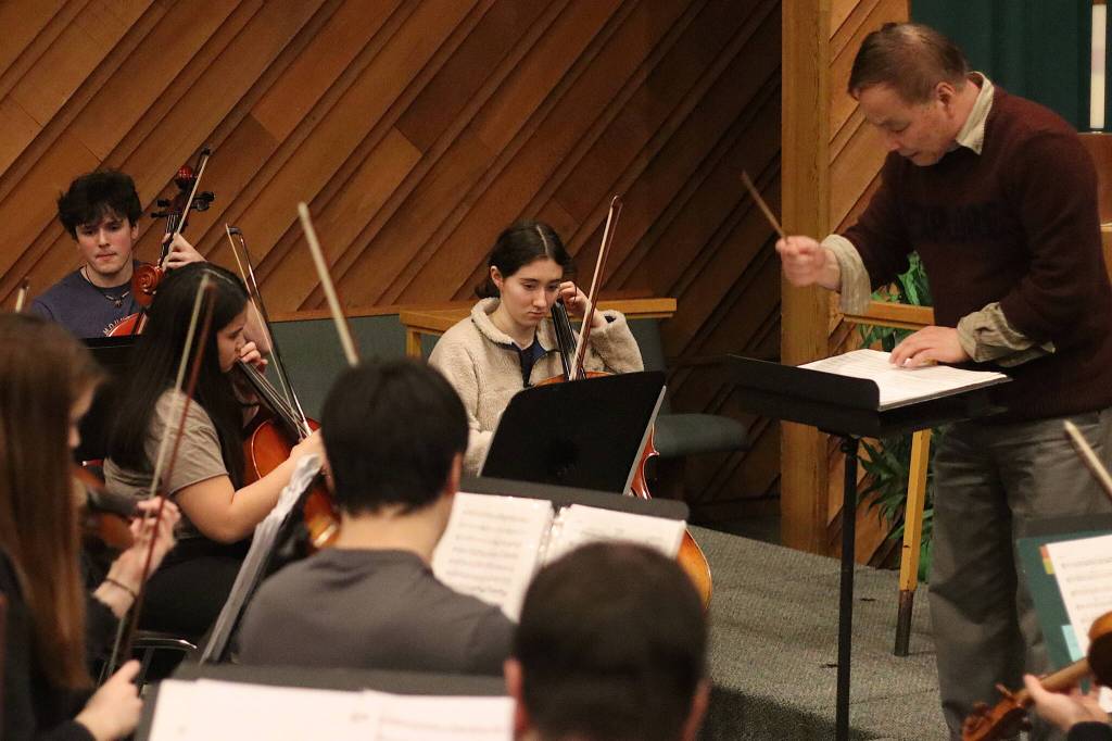 Cerys Hudson, 16, plays cello as Guo Hua Xia guides Juneau String Ensembles students through a rehearsal Sunday at Resurrection Lutheran Church for a concert Saturday at Ḵunéix̱ Hídi Northern Light United Church. Hudson and Xia were both part of the local group that participated in a performance at Carnegie Hall last summer. (Mark Sabbatini / Juneau Empire)