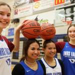 Sophomore twins Cailynn and Kerra Baxter, outside, and juniors twins Jaya and Mikah Carandang, inside, smile for a picture after their Monday night practice at Thunder Mountain High School. ( Clarise Larson / Juneau Empire)
