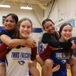 Sophomore twins Cailynn and Kerra Baxter, outside, and juniors twins Jaya and Mikah Carandang, inside, smile for a picture after their Monday night practice at Thunder Mountain High School. ( Clarise Larson / Juneau Empire)