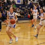 Cailynn Baxter (23) eyes the hoop on her way down the court during a home game win against Palmer High School. Her twin sister Kerra (22) and teammate Addi Wilson (25) can be seen in the background. (Ben Hohenstatt / Juneau Empire File)
