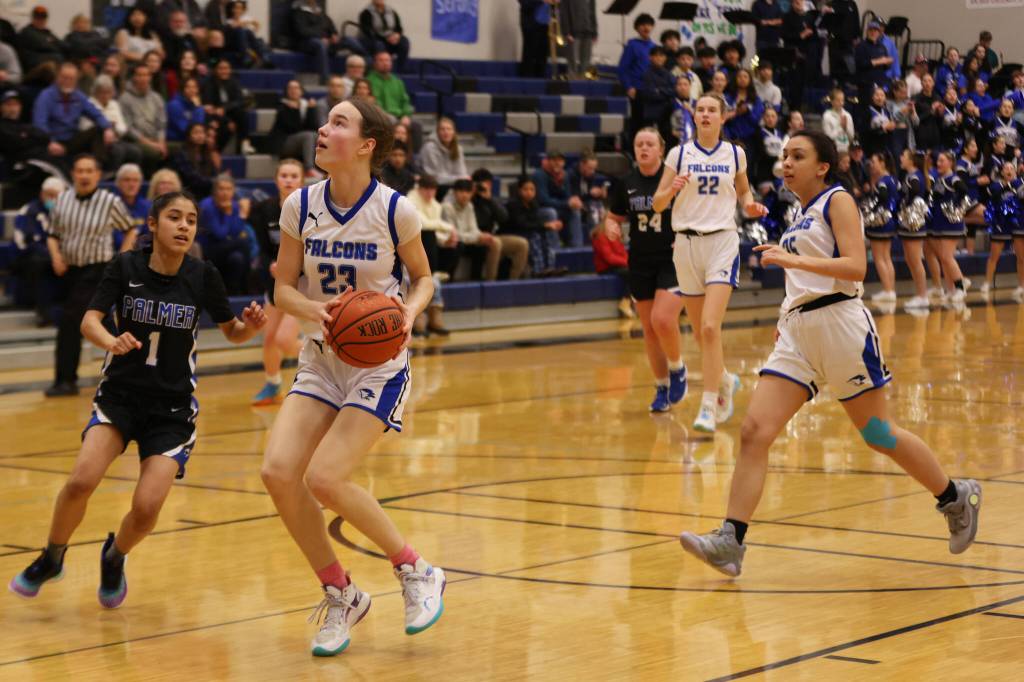 Cailynn Baxter (23) eyes the hoop on her way down the court during a home game win against Palmer High School. Her twin sister Kerra (22) and teammate Addi Wilson (25) can be seen in the background. (Ben Hohenstatt / Juneau Empire File)
