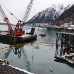 The privately owned 107-foot tugboat, the Tagish, sits partially below the water south of the downtown cruise ship docks Thursday morning as recovery efforts begin by the Coast Guard. (Clarise Larson / Juneau Empire)