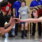 Two students face off for a match at the 2020 Southeast Alaska Middle School Wrestling Championship at Floyd Dryden Middle School on Friday, Feb. 14, 2020. The Juneau School District Board of Education on Tuesday accepted a donation that will provide the middle school with a new wrestling mat. (Peter Segall / Juneau Empire File)