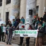 About 50 state employees, politicians and other supporters gather in front of the Alaska State Capitol for a midday rally on Friday. (Mark Sabbatini / Juneau Empire)