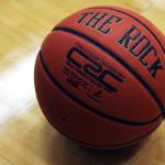 A high school basketball rests on a gym floor. (Ben Hohenstatt / Juneau Empire)