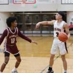 JDHS junior Alwen Carrillo sets up offense during a conference game against Ketchikan High School Friday night at home. Carrillo led his team in scores with a total of 17 points. (Jonson Kuhn / Juneau Empire)