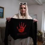 Clarise Larson / Juneau Empire
Kaelyn Schneider holds a sweatshirt featuring a red hand, a symbol of the missing and murdered Indigenous women movement, along with an email tag where people can send information regarding the disappearance her mother Tracy Lynn Day, who has been missing since Feb. 14 2019.
