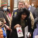 Alaska House Speaker Cathy Tilton, R-Wasilla, accepts a Valentines Day card from a Montessori Borealis preschool student in the hallway outside the House chamber at the Alaska State Capitol on Monday. A couple dozen youths from the Juneau Montessori program visited with their parents and teachers during the morning, lobbying for an increase in education funding. Tilton said during a subsequent press briefing she is not ruling out an increase, but is interested in outside the box alternatives. (Mark Sabbatini / Juneau Empire)