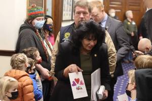 Alaska House Speaker Cathy Tilton, R-Wasilla, accepts a Valentines Day card from a Montessori Borealis preschool student in the hallway outside the House chamber at the Alaska State Capitol on Monday. A couple dozen youths from the Juneau Montessori program visited with their parents and teachers during the morning, lobbying for an increase in education funding. Tilton said during a subsequent press briefing she is not ruling out an increase, but is interested in outside the box alternatives. (Mark Sabbatini / Juneau Empire)