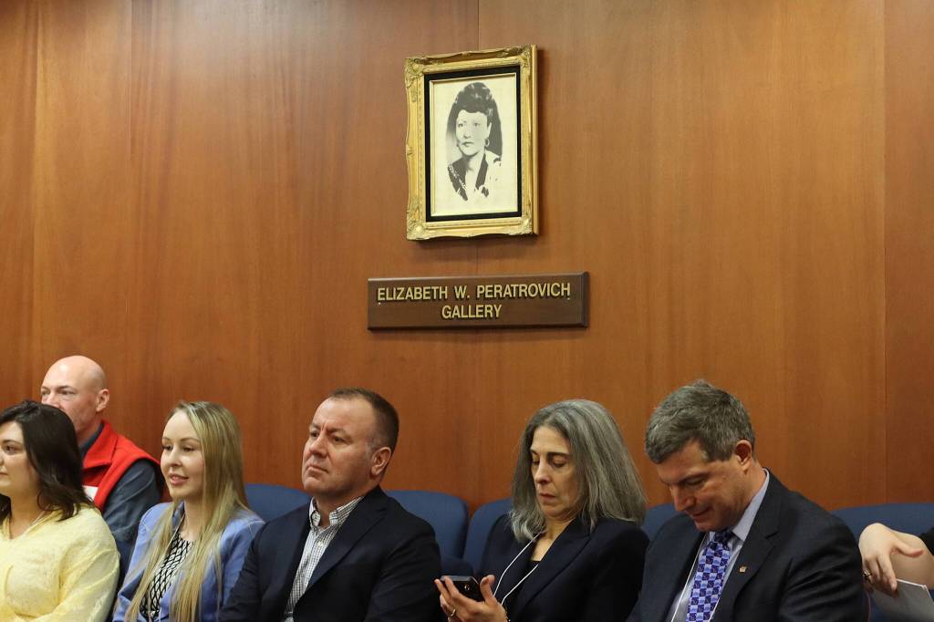 Guests in the Elizabeth Peratrovich Gallery in the House chambers at the Alaska State Capitol check messages and watch legislators arrive for Wednesdays floor session. The gallery is one of two in the House chambers named after famous Alaskans. (Mark Sabbatini/ Juneau Empire)