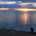 Visitors to Point Woronzof Park watch the sun set over Cook Inlet and Mount Susitna, also known as Sleeping Lady, on June 7, 2013, in Anchorage, Alaska. Alaska Gov. Mike Dunleavy has proposed a plan that could use the Cook Inlet basin for carbon sequestration. (AP Photo / Dan Joling)
