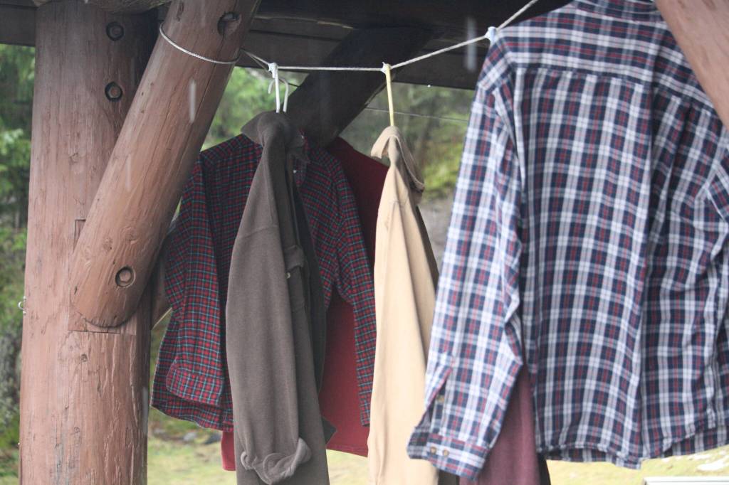 Daniel Sargents flannels blow in the breeze on Saturday during a special memorial service held in his honor at Raven Shelter. Guests were invited to take home one of Daniels shirts as a way of both remembering and honoring him. (Jonson Kuhn / Juneau Empire)