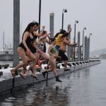 A group of University of Alaska Southeast students jump into the waters of Auke Bay on Saturday afternoon for the 25th UAS Polar Plunge. (Clarise Larson / Juneau Empire)