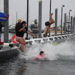 A group of University of Alaska Southeast students jump into the waters of Auke Bay on Saturday afternoon for the 25th UAS Polar Plunge. (Clarise Larson / Juneau Empire)