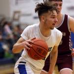 TMHS junior Thomas Baxter cuts toward the basket during a home win against Ketchikan. (Ben Hohenstatt / Juneau Empire)