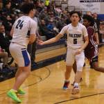 TMHS junior TJ Guevarra (5) hands off the ball to senior MJ Tupou (24) late in a home win against Ketchikan. (Ben Hohenstatt / Juneau Empire)