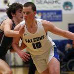 TMHS junior James Polasky (10) closes in on the hoop while Kayhi junior Jared Rhodes (15) works to close off that route. (Ben Hohenstatt / Juneau Empire)