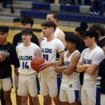 TMHS junior Thomas Baxter (30) stands with teammates before a 64-59 home win against Ketchikan as he is recognized for breaking the 1,000-point mark. (Ben Hohenstatt / Juneau Empire)