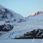 A snowman sits on Mendenhall Lake as the sun sets over the glacier Monday evening. (Clarise Larson / Juneau Empire)