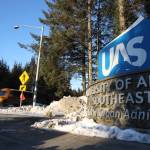 A school bus drives past the entrance of The University of Alaska Southeast on Tuesday afternoon. Pat Pitney, president of the statewide university system, highlighted ongoing and new efforts to by campuses including UAS to lure students into the teaching programs and subsequently remain as public school teachers in the state. (Clarise Larson / Juneau Empire)