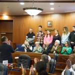 Six Ukrainians who are living in Juneau get a round of applause from state Senators and guests during a floor session Friday, the one-year anniversary of Russias invasion of Ukraine. State Sen. Jesse Kiehl, D-Juneau, introduced the families and read a collective statement from the families thanking locals who have helped resettlement efforts and asking for continuing support of their homeland. (Mark Sabbatini / Juneau Empire)