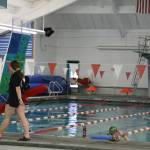 A lifeguard walks the perimeter of the Augustus Brown Pool Friday morning. The 50-year-old City and Borough of Juneau-owned pool is planned to close on April 3 of this year and will remain closed until early 2024 to undergo $8 million in renovations. (Clarise Larson / Juneau Empire)