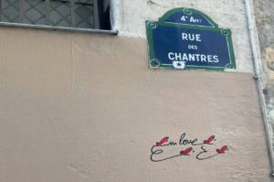 Near the spot where Héloïse and Peter Abelard fell in love, concise graffiti offers a testament of more recent lovers, four red hearts flitting like butterflies around two simple words in English: in love. (Courtesy Photo)