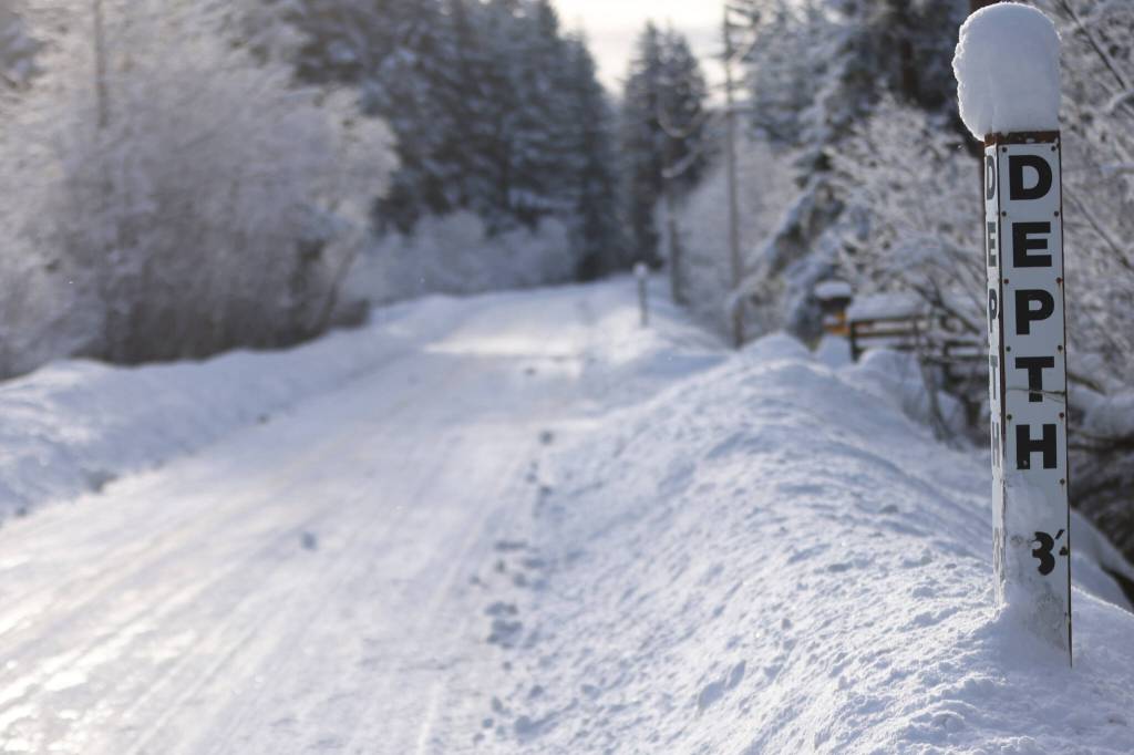 A berm along Montana Creek Road nears the 3-foot mark on a post. According to National Weather Service in Juneau, a total of 14.3 inches of snow was recorded at Juneau International Airport from midnight to midnight Friday, which is a new recorded snowfall high for Feb. 24. (Ben Hohenstatt / Juneau Empire)