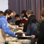 Attendees line up for soul food on Saturday served at the Black Awareness Associations Rise event at the Juneau Arts and Culture Center. The year marks the events first return to Juneau in five years. (Jonson Kuhn / Juneau Empire)