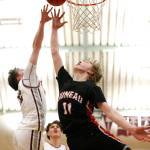 Kayhis Archie Dundas (22) attempts to block Juneaus Sean Oliver (11) during Juneaus 71-52 loss to Kayhi on Friday at the Clarke Cochrane Gymnasium. (Christopher Mullen / Ketchikan Daily News)