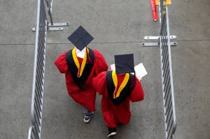 FILE - New graduates walk into the High Point Solutions Stadium before the start of the Rutgers University graduation ceremony in Piscataway Township, N.J., on May 13, 2018. The Supreme Court is about to hear arguments over President Joe Bidens student debt relief plan. Its a plan that impacts millions of borrowers who could see their loans wiped away or reduced. (AP Photo / Seth Wenig)