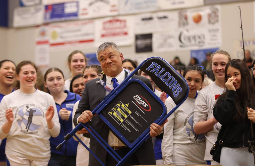 Ben Hohenstatt / Juneau Empire 
TMHS assistant coach Arnold Ibias, who is retiring after 20 years of coaching, holds a chair he was gifted during a ceremony amid senior night celebrations. The chair was given to him in deceptive, appliance-sized packaging, which Ibias said concerned him. The longtime sideline presence said that hes played a lot of jokes over the years, so he wasnt sure what could be in the box. TMHS head coach Andy Lee, who effusively complimented Ibias, said although Ibias doesnt sit much by nature, he has been a vocal critic of the uncomfortable sideline chairs available to coaches. Ibias, who was also given a fishing pole during the ceremony, said the gift is a great gesture.