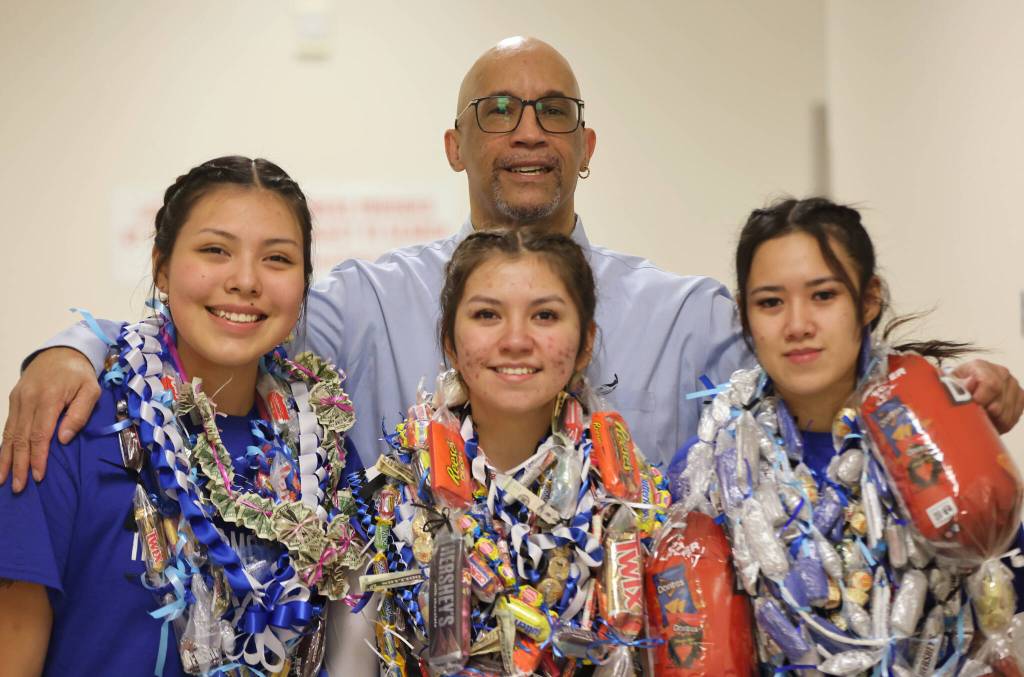Ben Hohenstatt / Juneau Empire 
TMHS seniors Kiara Kookesh, Kayla Woodbury and Tyra Aguirre pose for a photo with coach Andy Lee on senior night.