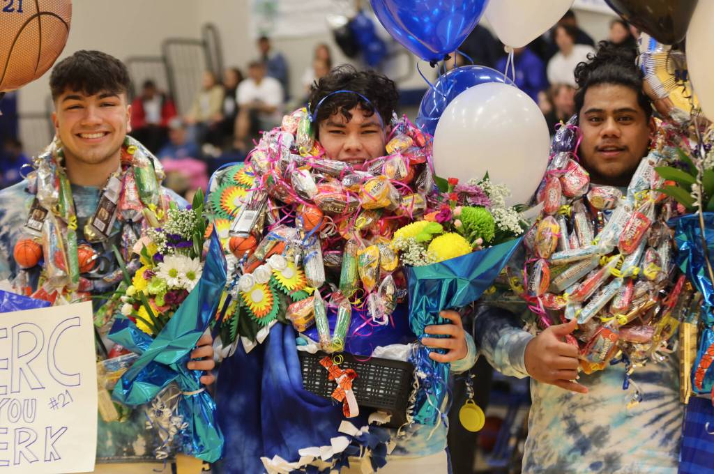 Ben Hohenstatt / Juneau Empire 
TMHS seniors Caden Mercer, MJ Tupou and Sam Sika pose together for a photo on senior night ahead of a win against JDHS.