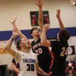 TMHS junior Thomas Baxter (30) watches as his game-winning shot makes its way past the arms of JDHS senior Orion Dybdahl (20) and JDHS senior Kai Hargrave (24) who contested the shot closely. (Ben Hohenstatt / Juneau Empire)