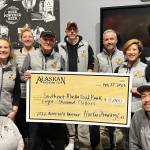Alaskan Brewing Co. staff presents a check to Southeast Alaska Food Bank director Chris Schapp on Tuesday as part of the companys Cheers to the Southeast Alaska Food Bank! celebration. The evening also celebrated the selection of Alaskan Brewing Co. next year recipient SEADOGS. (Courtesy Photo / Erin Youngstrom)