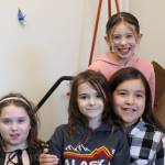 Left to right, Lilah Gaguine, Maddie Lesh, Lyndley Nakamura and Hallie Reid (top) are all smiles after taking 10th place in this years Battle of the Books competition on Thursday at Borealis Elementary School via phone conference. (Jonson Kuhn / Juneau Empire)