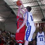 Petersburg Vikings forward Cameron Severson (13) blocks a shot by Juneau-Douglas Crimson Bears forward Ryan Fagerstrom (22) during the 2006 Region V 3A/4A cross-over championship game at Ketchikan.