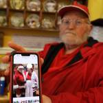 Dale Hudson holds his phone showing a photo of him and his late wife, Suzanne, dressed up as Mr. and Mrs. Claus. Dale is in the process of liquidating his wifes store, Nanas Attic, after her recent death in late February. (Clarise Larson / Juneau Empire)